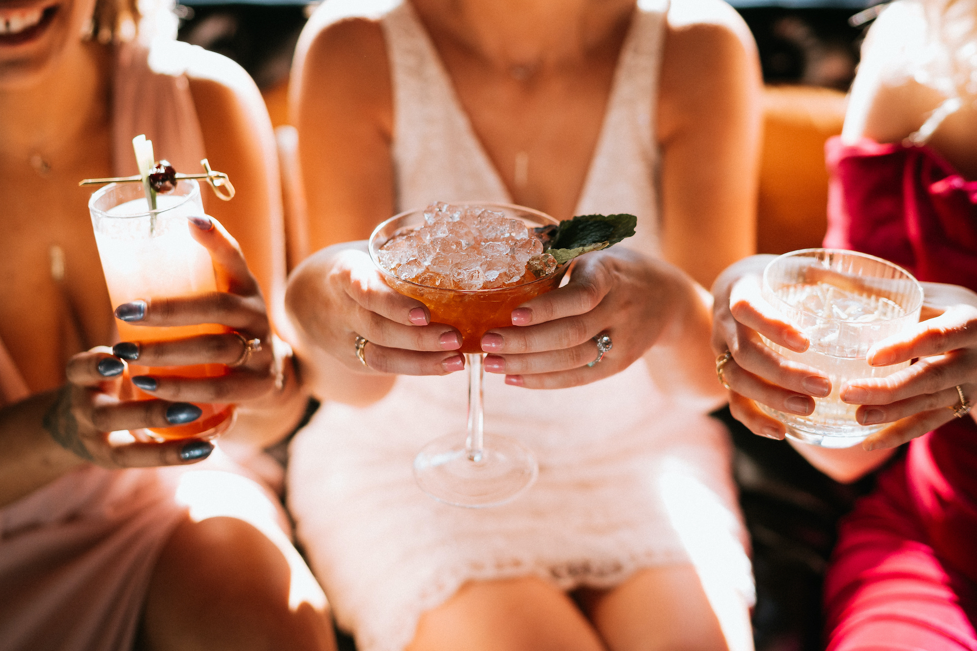 friends holding cocktails