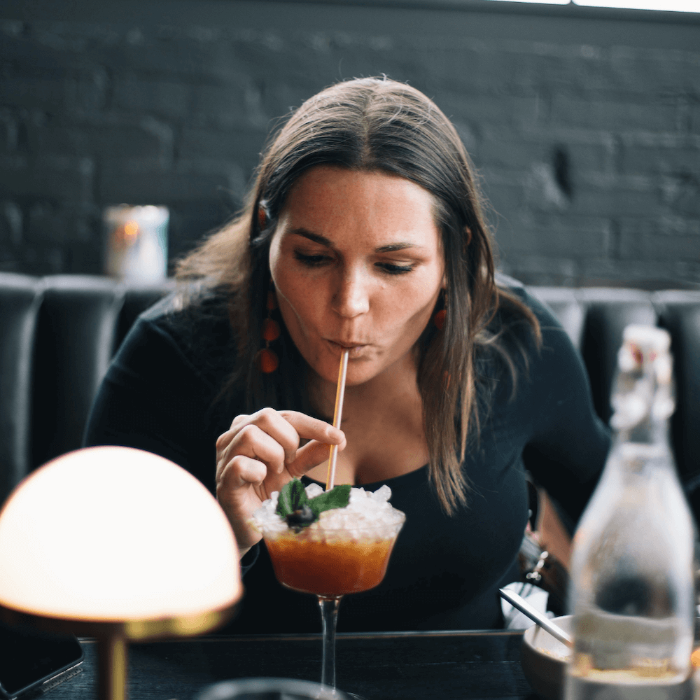 person sipping cocktail